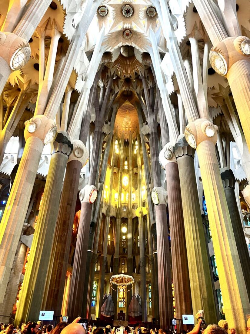 Columns and the nave in the interior of La Sagrada familia with light shining through. The magic of the temple of light.